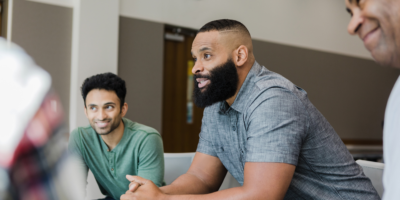 Men participating in a group discussion or support meeting