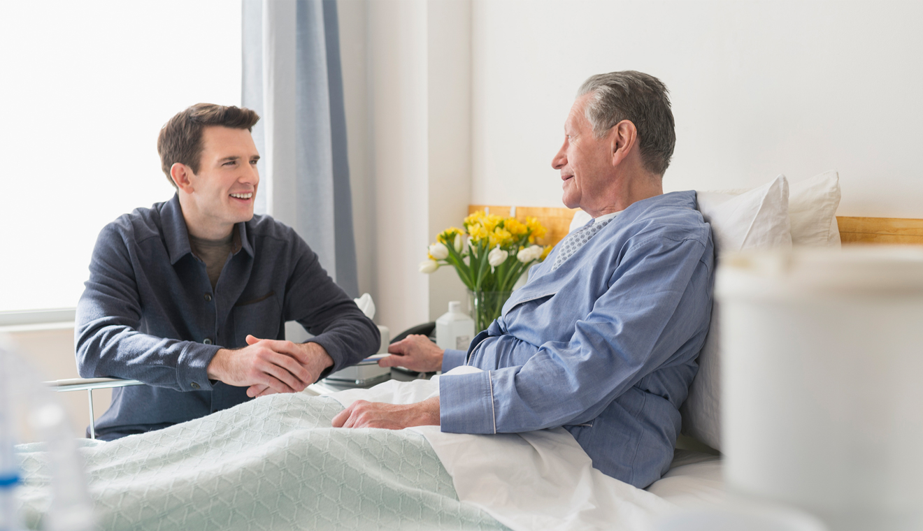 Two people talking together in a health care room