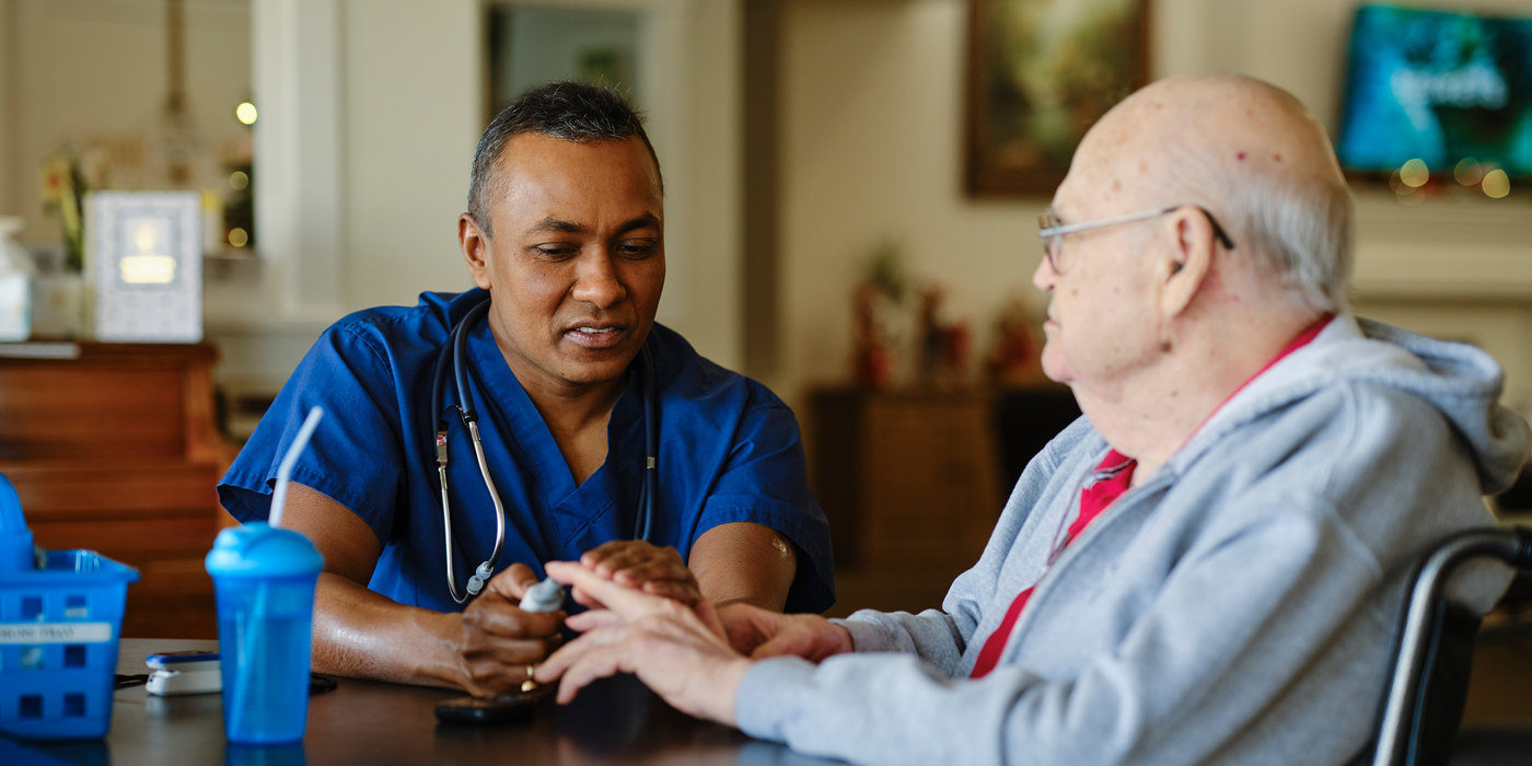 Doctor treating patient at table