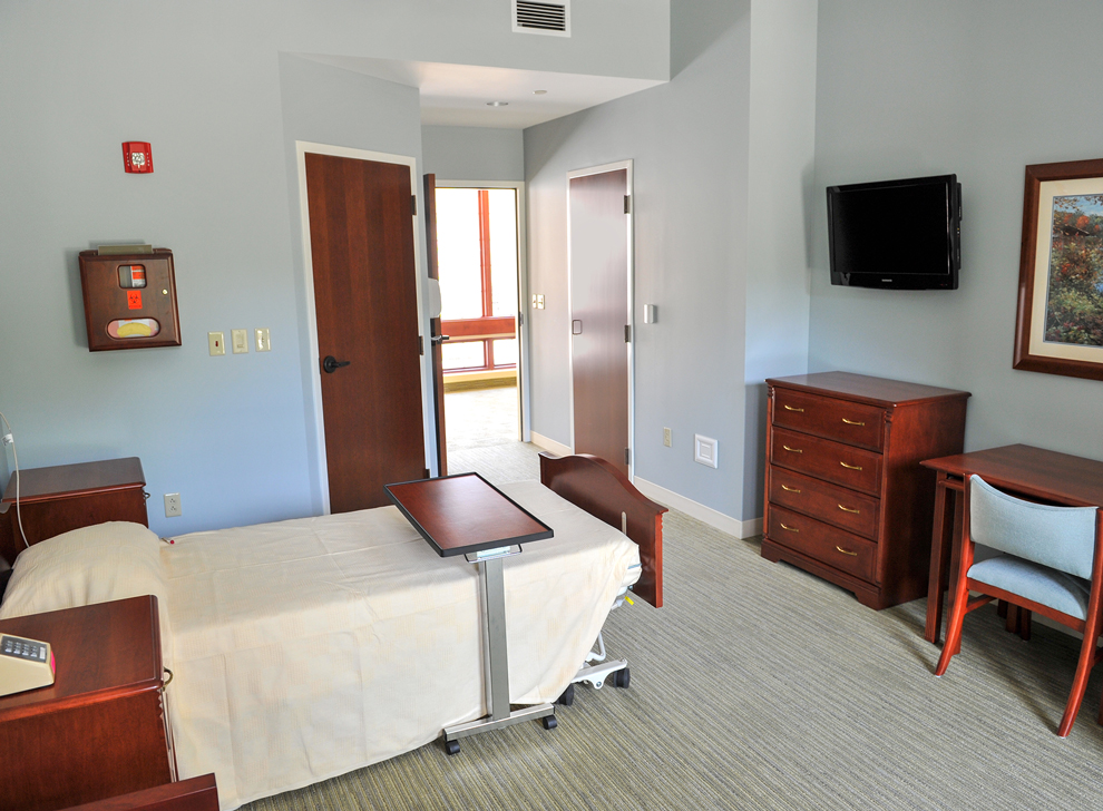 Private room with bed, furniture, and television.