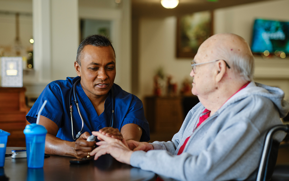 Doctor treating patient at table