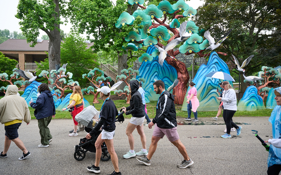 People walking past colorful outdoor art installation
