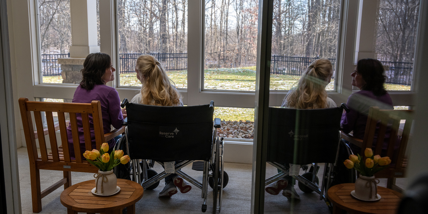 People setting in front of window talking