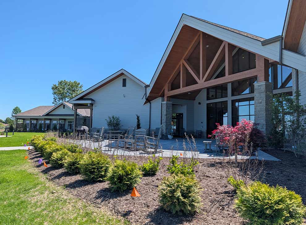 Rear exterior courtyard and outdoor social space adjacent to the facility overlooking the shoreline